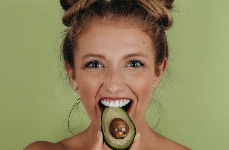 девушка ест авокадо